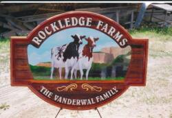 cow on cedsr sign for dairy