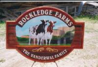 cow on cedsr sign for dairy