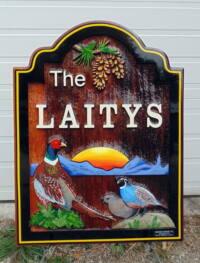 Beautifully artist painted sand blasted cedar sign for Vernon BC