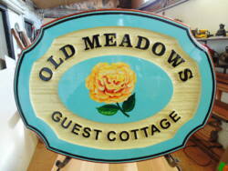 Old Meadows guest house in the mission area of Kelowna BC Sandblasted cedar wood sign hand painted.By Condor signs Vernon BC