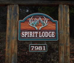 Spirit Lodge bed and breakfast wood sign sandblasted and artist painted.Located in Vernon BC custom made by Condor signs.