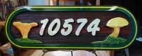 Wild mushrooms are dipicted on this cedar sandblasted sign by Condor Signs Vernon BC.Next level custom signs.This one is in Kelowna BC