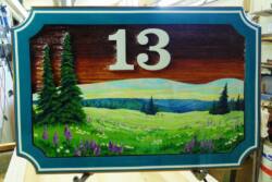 Original handmade sandblasted address sign.Artist painted wood sign By Condor signs vernon BC.