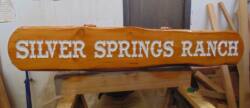 Custom carving and painting a customers slab of wood..Condor Signs works on wood signs of all kinds.
