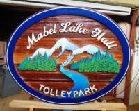 Mable Lake BC Canada cedar sandblasted sign for the community hall.This is artist painted and finished to last many years.Condor signs is the go to business for your wood sign needs.